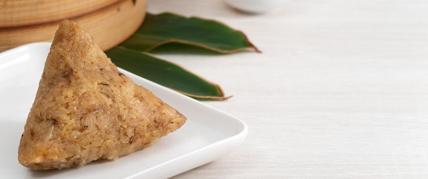 Zongzi. Rice dumpling for Chinese traditional Dragon Boat Festival (Duanwu Festival)  on bright wooden table background.