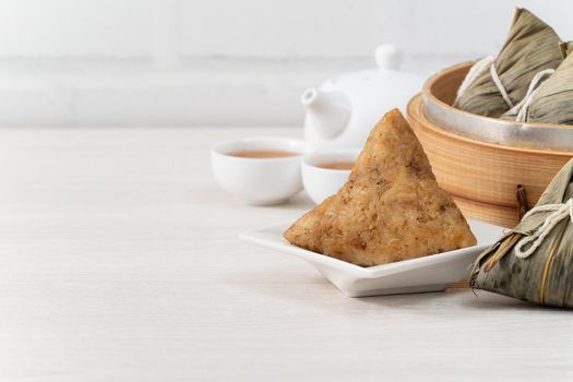 Zongzi. Rice dumpling for Chinese traditional Dragon Boat Festival (Duanwu Festival)  on bright wooden table background.