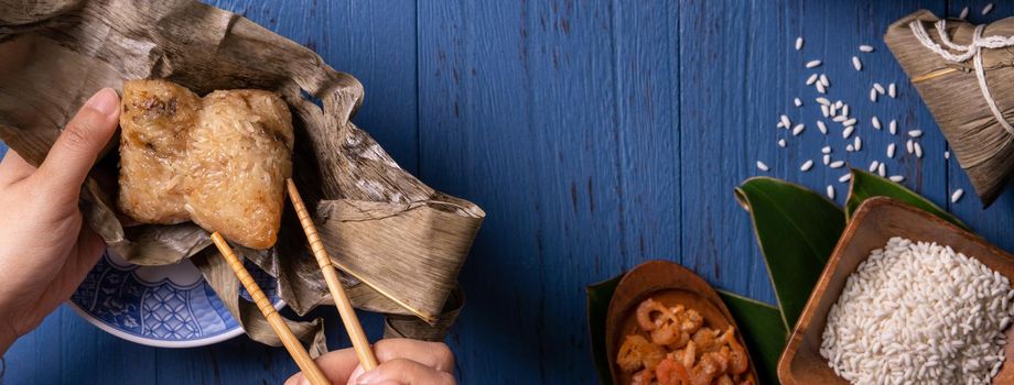 Zongzi rice dumpling with ingredients top view for Chinese traditional Dragon Boat Festival (Duanwu Festival) over blue wooden table background.