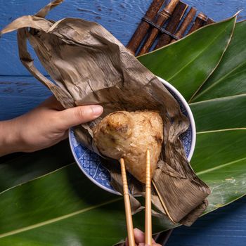 Zongzi rice dumpling with ingredients top view for Chinese traditional Dragon Boat Festival (Duanwu Festival) over blue wooden table background.