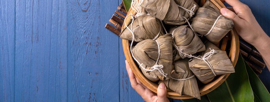 Zongzi rice dumpling with ingredients top view for Chinese traditional Dragon Boat Festival (Duanwu Festival) over blue wooden table background.