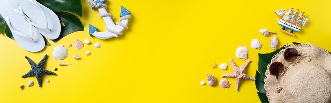 Summer beach design concept. Top view of holiday travel with shells, hat, slipper on yellow background.