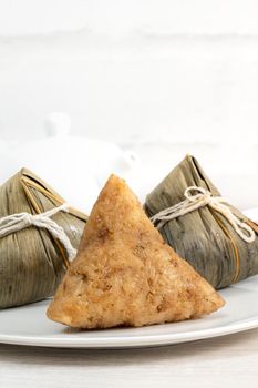 Zongzi. Rice dumpling for Chinese traditional Dragon Boat Festival (Duanwu Festival)  on bright wooden table background.