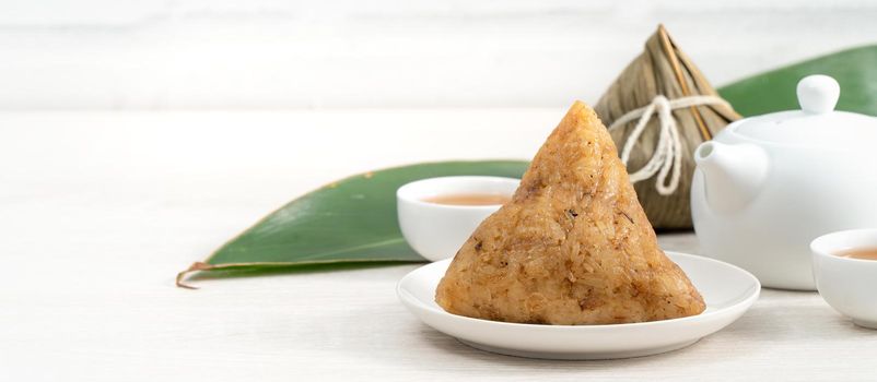 Zongzi. Rice dumpling for Chinese traditional Dragon Boat Festival (Duanwu Festival)  on bright wooden table background.