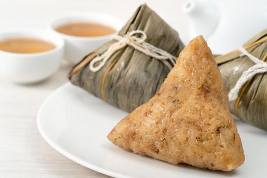 Zongzi. Rice dumpling for Chinese traditional Dragon Boat Festival (Duanwu Festival)  on bright wooden table background.