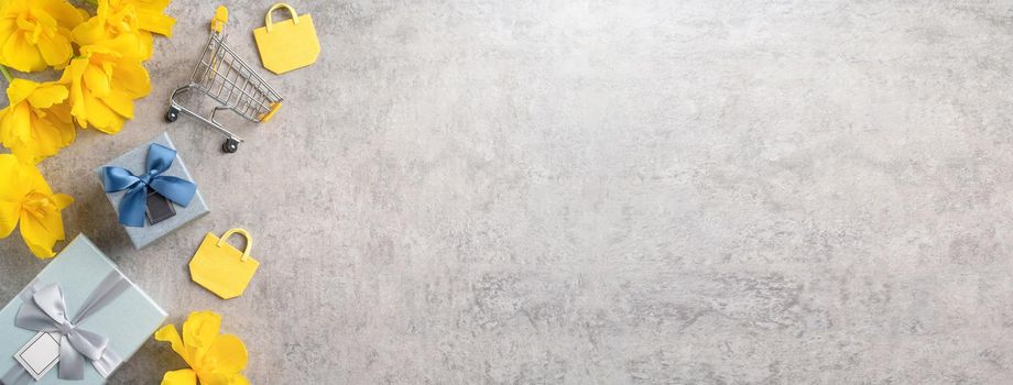 Concept of Mother's day holiday gift shopping greeting design with yellow tulip flower bouquet on gray background