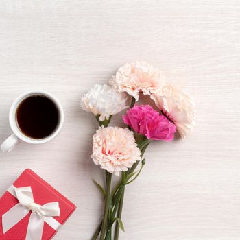 Mother's Day design concept. Top view of beautiful carnation flower and holiday gift idea with copy space.
