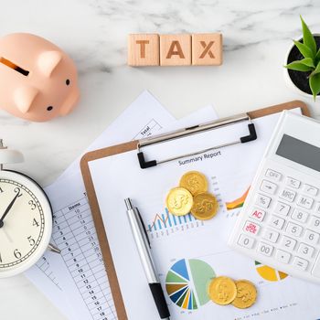Top view of reading the overview and calculating, paying tax concept on marble white table.