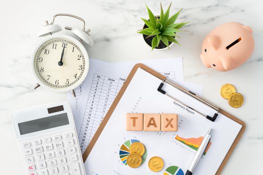 Top view of reading the overview and calculating, paying tax concept on marble white table.