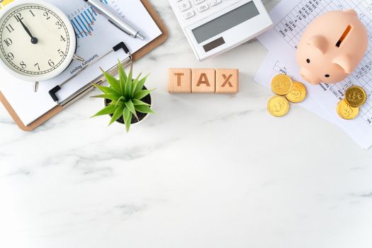 Top view of reading the overview and calculating, paying tax concept on marble white table.