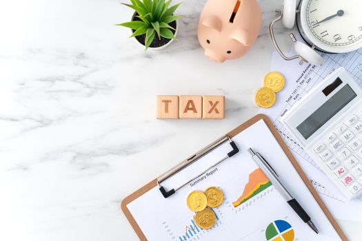 Top view of reading the overview and calculating, paying tax concept on marble white table.