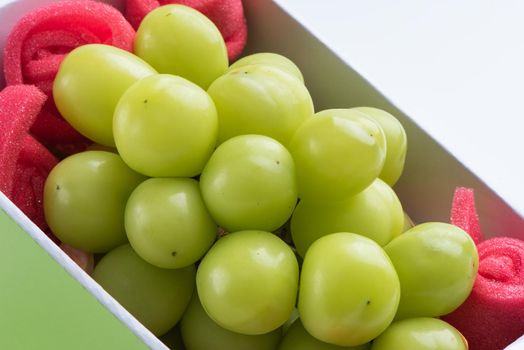 Close up of beautiful boxed Shrine Muscat green grape isolated on white background, clipping path cut out.