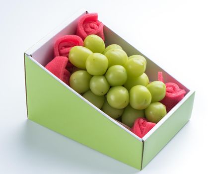 Close up of beautiful boxed Shrine Muscat green grape isolated on white background, clipping path cut out.