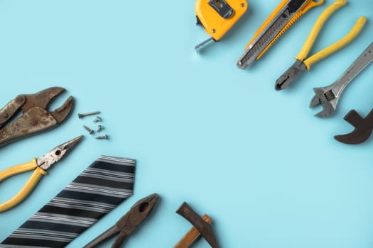 Top view design concept of Father's day and labor day with working tools on blue background.