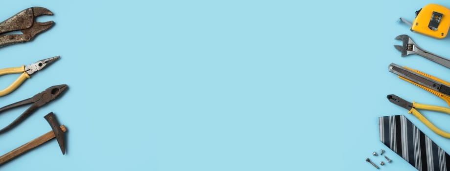 Top view design concept of Father's day and labor day with working tools on blue background.