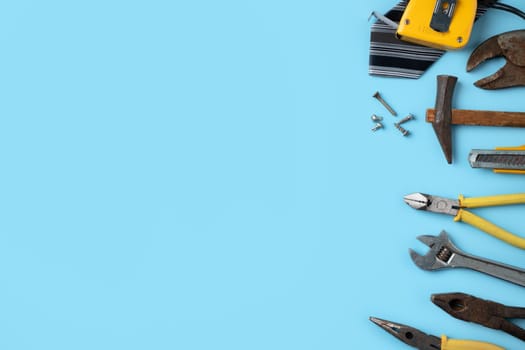 Top view design concept of Father's day and labor day with working tools on blue background.