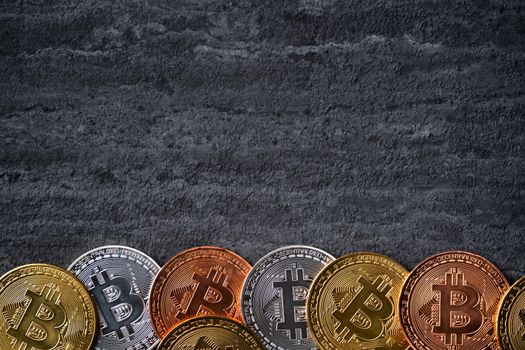 Top view business concept of bitcoin cryptocurrency money on dark black slate table background.