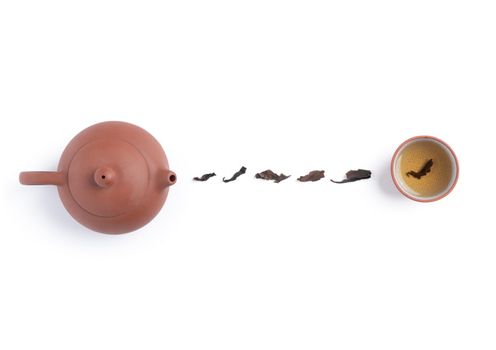 Top view of fresh black tea with kettle teapot and leaves in Taiwan, Asian culture design concept layout.