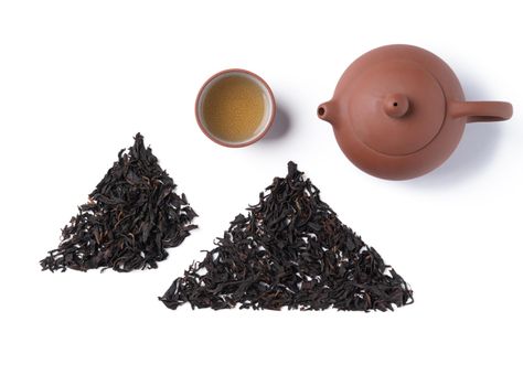 Top view of fresh black tea with kettle teapot and leaves in Taiwan, Asian culture design concept layout.