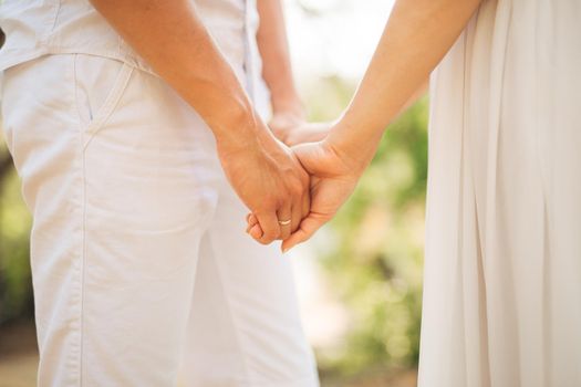 Bride and groom holding hands. Wedding in Montenegro