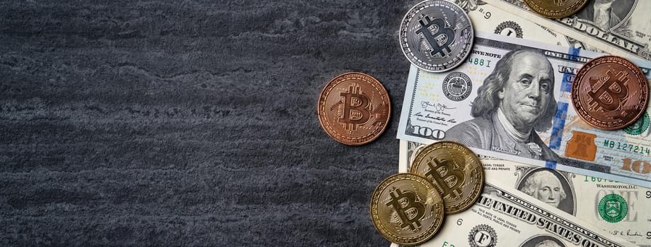 Business top view design concept of cryptocurrency bitcoin with USD Dollar paper currency money over dark black table background.