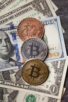 Business top view design concept of cryptocurrency bitcoin with USD Dollar paper currency money over dark black table background.
