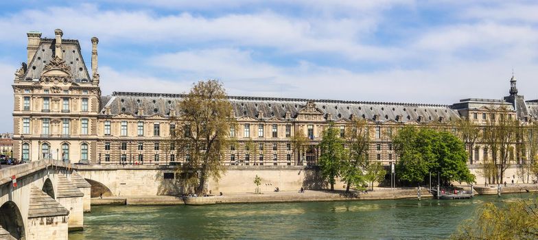 Beautiful historic buildings of Paris and one of the oldest bridge ( Pont Royal ) across Seine River. France. April 2019