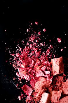 Crushed cosmetics, mineral organic eyeshadow, blush and cosmetic powder isolated on black background, makeup and beauty banner, flatlay design.