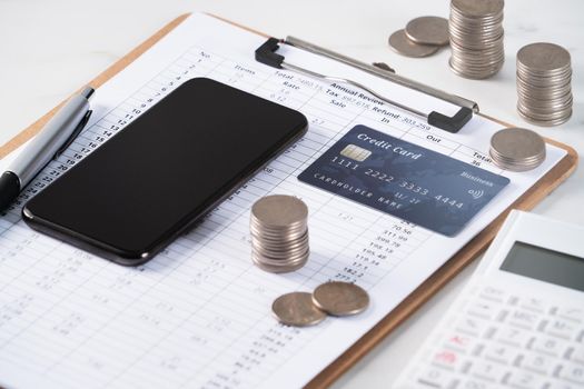 Design concept of annual summary analysis review report with calculator, paying with electronic device and credit card.