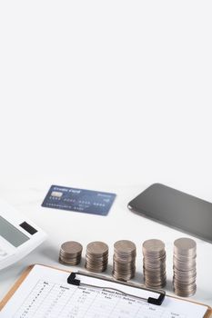 Design concept of annual summary analysis review report with calculator, paying with electronic device and credit card.