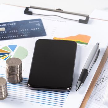 Design concept of annual summary analysis review report with calculator, paying with electronic device and credit card.