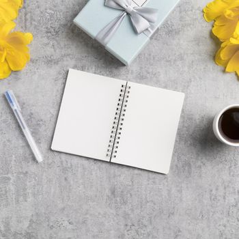Concept of Mother's day holiday gift idea greeting design with yellow tulip flower bouquet on gray background