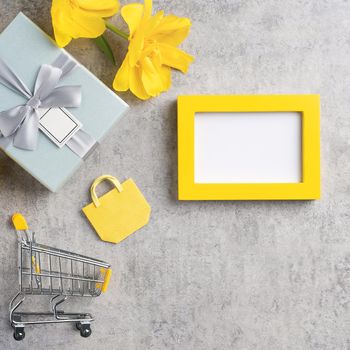 Concept of Mother's day holiday gift shopping greeting design with yellow tulip flower bouquet on gray background