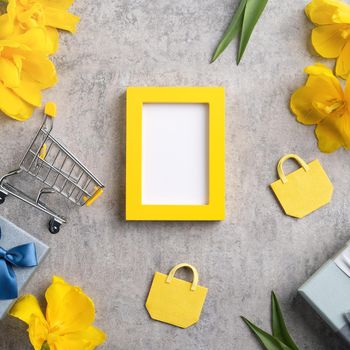 Concept of Mother's day holiday gift shopping greeting design with yellow tulip flower bouquet on gray background