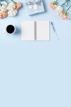 Design concpet of Mother's Day greeting with carnation flower, holiday gift idea and notebook diary on mother's desk background.