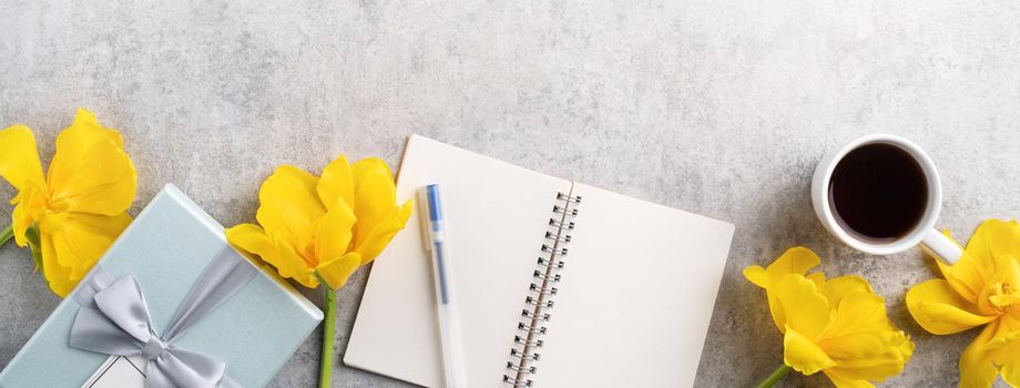 Concept of Mother's day holiday gift idea greeting design with yellow tulip flower bouquet on gray background