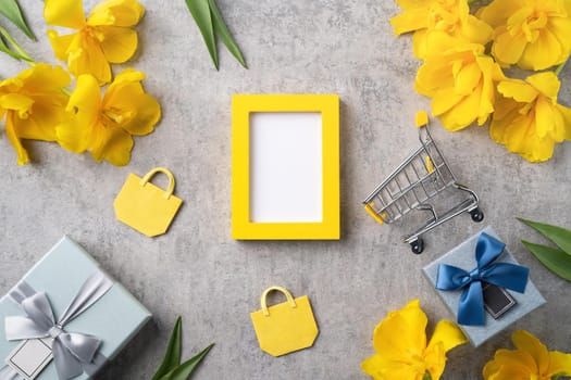 Concept of Mother's day holiday gift shopping greeting design with yellow tulip flower bouquet on gray background