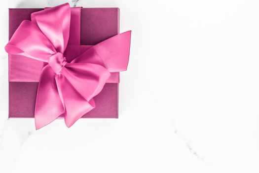 Birthday, wedding and girly branding concept - Pink gift box with silk bow on marble background, girl baby shower present and glamour fashion gift for luxury beauty brand, holiday flatlay art design