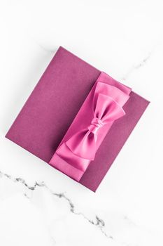 Birthday, wedding and girly branding concept - Pink gift box with silk bow on marble background, girl baby shower present and glamour fashion gift for luxury beauty brand, holiday flatlay art design