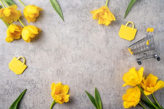 Concept of Mother's day holiday gift shopping greeting design with yellow tulip flower bouquet on gray background