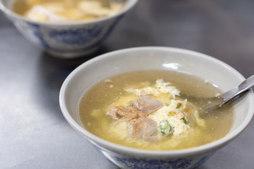 Delicious street food pig bone marrow soup with boiled egg drop in Changhua, Taiwan.