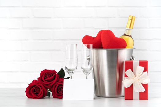 Valentine's Day celebration with wine, gift and rose bouquet for holiday greeting.