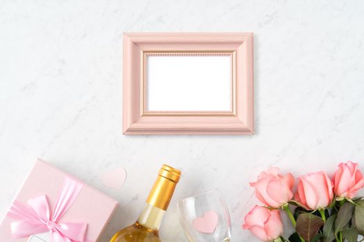 Giftbox and pink rose flower on marble white table background for Valentine's Day holiday greeting design concept.