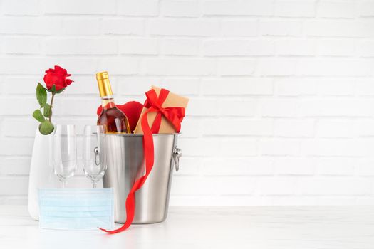 Valentine's Day celebration with wine, bouquet and face mask protection concept during this hard time.
