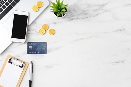 Top view of financial plan concept with credit card, laptop, note on white office table background.
