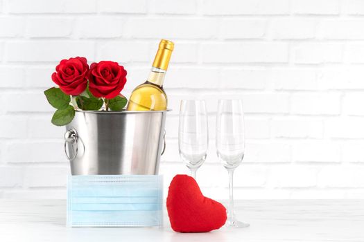 Valentine's Day celebration with wine, bouquet and face mask protection concept during this hard time.