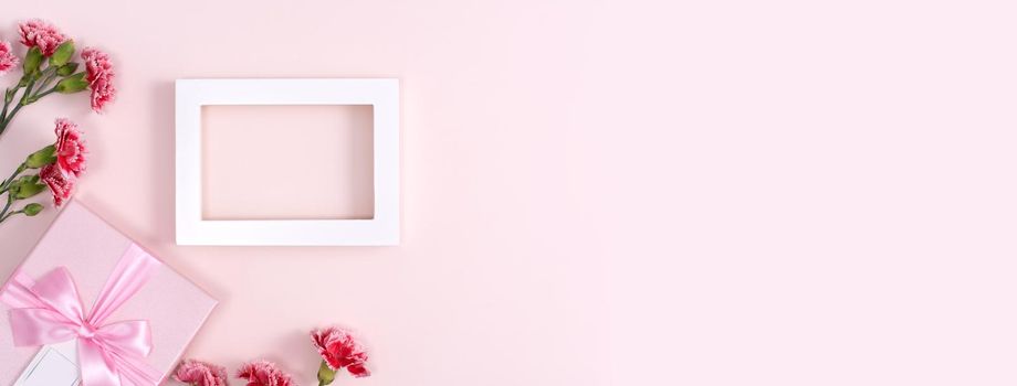 Concept of Mother's day holiday greeting background design  with carnations bouquet on pink background