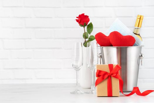 Valentine's Day celebration with wine, bouquet and face mask protection concept during this hard time.