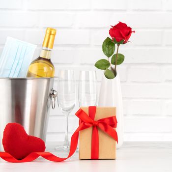 Valentine's Day celebration with wine, bouquet and face mask protection concept during this hard time.
