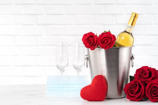 Valentine's Day celebration with wine, bouquet and face mask protection concept during this hard time.